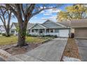Well-kept home featuring an attached garage and a long driveway, all set on a manicured lot at 8533 Sw 93Rd Pl # C, Ocala, FL 34481