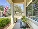 Front porch adorned with a table, potted plant, and view of a landscaped yard at 9346 Sw 73Rd St, Ocala, FL 34481