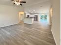 Spacious living room boasts stylish floors with an open-concept layout to the modern kitchen with stainless appliances at 1370 Sw Obee Ridge Rd, Dunnellon, FL 34432