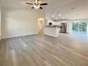 Open-concept living room featuring stylish flooring seamlessly connects to a modern kitchen with stainless appliances at 1370 Sw Obee Ridge Rd, Dunnellon, FL 34432