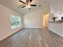 Bright living room boasts neutral walls, stylish light-colored floors, and a large window with natural light at 1370 Sw Obee Ridge Rd, Dunnellon, FL 34432