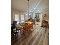 Open dining area with table and chairs next to an open kitchen with stainless appliances at 13949 Se 53Rd Ave, Summerfield, FL 34491