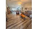 Spacious living room features stylish wood floors, a ceiling fan, and ample natural light at 13949 Se 53Rd Ave, Summerfield, FL 34491