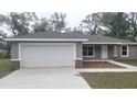 Charming single-story home with a two-car garage and a well-maintained lawn at 17718 Sw 112Th Ln, Dunnellon, FL 34432