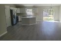 Modern kitchen with stainless steel appliances, an island, and a view of the backyard at 17718 Sw 112Th Ln, Dunnellon, FL 34432