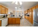 Bright kitchen featuring oak cabinets, granite countertops, stainless steel appliances, and an adjacent breakfast nook at 17959 Se 89Th Natchez Ave, The Villages, FL 32162