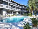 Community pool with lounge chairs and well-maintained landscaping at 20800 River Dr # A17, Dunnellon, FL 34431
