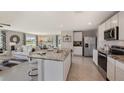 Modern, open-concept kitchen with granite countertops, stainless steel appliances, and an island with breakfast bar at 2934 Ne 21St Terrace Rd, Ocala, FL 34470