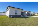 Corner view of home showing manicured lawn and landscaping details at 3352 Sw 127Th Lane Rd, Ocala, FL 34473