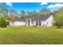 Well-maintained one-story home with a sprawling lawn, arched windows, and a welcoming entrance area at 3621 Sw 52Nd Ter, Ocala, FL 34474