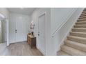 Inviting entryway with a staircase, wood floors, and neutral decor at 4236 Sw 53Rd Lane Rd, Ocala, FL 34474