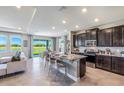 Open-concept kitchen with granite countertops, stainless steel appliances, and a large island overlooking the water view at 4250 Sw 53Rd Lane Rd, Ocala, FL 34474