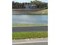 Scenic view of a lake with colorful buildings in the background at 4954 Sw 40Th Pl, Ocala, FL 34474