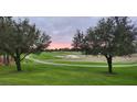 Scenic view of a manicured golf course with sand traps and a walking path at sunrise at 5111 Nw 35Th Pl, Ocala, FL 34482