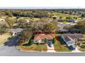 A lovely aerial shot showcasing the property's manicured lawn and proximity to the golf course at 8740 Se 140Th Place Rd, Summerfield, FL 34491