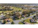 A high angle view of the homes near the golf course surrounded by trees in the area at 8740 Se 140Th Place Rd, Summerfield, FL 34491