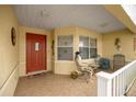 Inviting front porch with chairs and a skeleton statue at 9710 Sw 96Th St, Ocala, FL 34481