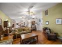 Spacious living room with hardwood floors and two ceiling fans at 9710 Sw 96Th St, Ocala, FL 34481