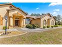 Close up view of the home's front exterior with decorative stone accents and manicured shrubbery at 11267 Sw 51St Ave, Ocala, FL 34476