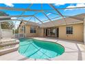 Relaxing covered pool area featuring a kidney-shaped pool and spacious deck at 11267 Sw 51St Ave, Ocala, FL 34476