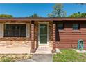 Inviting front door with brick accents and a cozy porch area, showcasing the home's curb appeal at 1505 Ne 33Rd Pl, Ocala, FL 34479