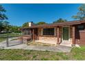 Brick-accented front entrance with a well-manicured lawn and a secure fence at 1505 Ne 33Rd Pl, Ocala, FL 34479