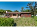 Inviting single-story home featuring a mix of brick and wood exterior with lush front yard at 1505 Ne 33Rd Pl, Ocala, FL 34479