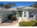 Attractive home entrance with manicured shrubbery, stone accents, and a paved walkway to the front door at 15304 Sw 15Th Terrace Rd, Ocala, FL 34473