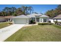 Charming single-story home with a well-manicured lawn, lovely landscaping, and a spacious two-car garage at 15304 Sw 15Th Terrace Rd, Ocala, FL 34473