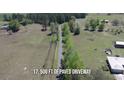 An aerial view of 17,500 ft. of paved driveway leading to a property amidst a green landscape at 2061 Nw 165Th Court Rd, Dunnellon, FL 34432