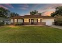 Charming single-story home featuring a well-manicured lawn, brick accents, and a cozy, inviting curb appeal at 22 Banyan Dr, Ocala, FL 34472