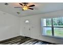 Bright living room featuring laminate floors, modern ceiling fan and a window view at 3 Dogwood Drive Loop, Ocala, FL 34472