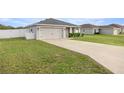 A charming house with a two-car garage, well-manicured lawn, and white picket fence at 5537 Se 91St Pl, Ocala, FL 34480