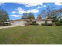 Charming single-story home featuring a well-manicured lawn and attached one car garage at 6718 Cherry Rd, Ocala, FL 34472