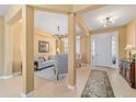 Bright foyer with tile flooring, white front door, and views of the living room and formal entry at 6865 Sw 97Th Terrace Rd, Ocala, FL 34481