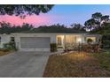 Charming single-story home with a two-car garage, and well-maintained front yard at sunset at 9581 Sw 85Th Ave # D, Ocala, FL 34481