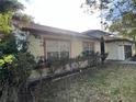 Single story home with well maintained landscaping and a mix of shade trees and flowering bushes at 10 Hickory Loop, Ocala, FL 34472
