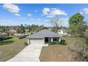 Well-maintained single-story home with a spacious front yard, two-car garage, and inviting curb appeal at 10400 Sw 50Th Ct, Ocala, FL 34476