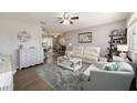 Bright living room with plush rug, modern furniture, and an open layout that connects to the dining and kitchen areas at 11475 Sw 85Th Ave, Ocala, FL 34481