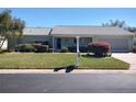 Well-maintained single-story home with green lawn and mature shrubbery at 14191 Sw 115Th Ter, Dunnellon, FL 34432