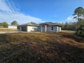 Attractive single-story home with a spacious driveway and a neatly maintained yard at 15 Locust Trak, Ocala, FL 34472