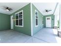 Spacious covered front porch with ceiling fans and views of the neighborhood at 2735 Se 19Th Ct, Ocala, FL 34471
