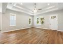 Bright living room featuring hardwood floors, tray ceiling, and lots of natural light at 2735 Se 19Th Ct, Ocala, FL 34471