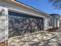 Attached two-car garage with gray door, concrete driveway and matching exterior at 4541 Se 30Th St, Ocala, FL 34480