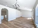 Open concept living room showcasing modern lighting, arched doorway and wood flooring at 4541 Se 30Th St, Ocala, FL 34480