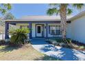 Charming home featuring a welcoming front porch, beautiful landscaping, and a freshly painted exterior at 5037 Sw 109Th Loop, Ocala, FL 34476