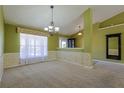 Spacious living room with large windows, decorative wallpaper, and neutral carpeting at 5037 Sw 109Th Loop, Ocala, FL 34476
