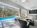 Inviting screened-in lanai boasts a sparkling pool, seating area, and outdoor bar, perfect for entertaining at 5150 Se 47Th Court Rd, Ocala, FL 34480