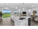 Open-concept living area featuring an island with a sink, plus a large sliding glass door to the yard at 5270 Nw 33Rd Pl, Ocala, FL 34482