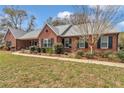 Attractive single-Gathering home showcasing manicured landscaping, a walkway, and a brick exterior at 5560 Ne 31St Ter, Ocala, FL 34479